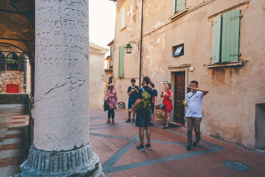 Sirmione: Lake Garda Boat, Grotte di Catullo & Walking Tour - Cruising Lake Garda and spotting the Sirmione peninsula from the water